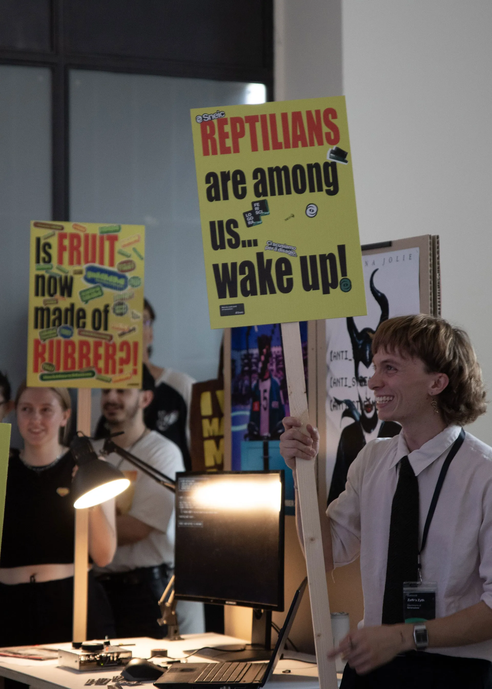 Close-up of a guy holding a conspiracy theory sign