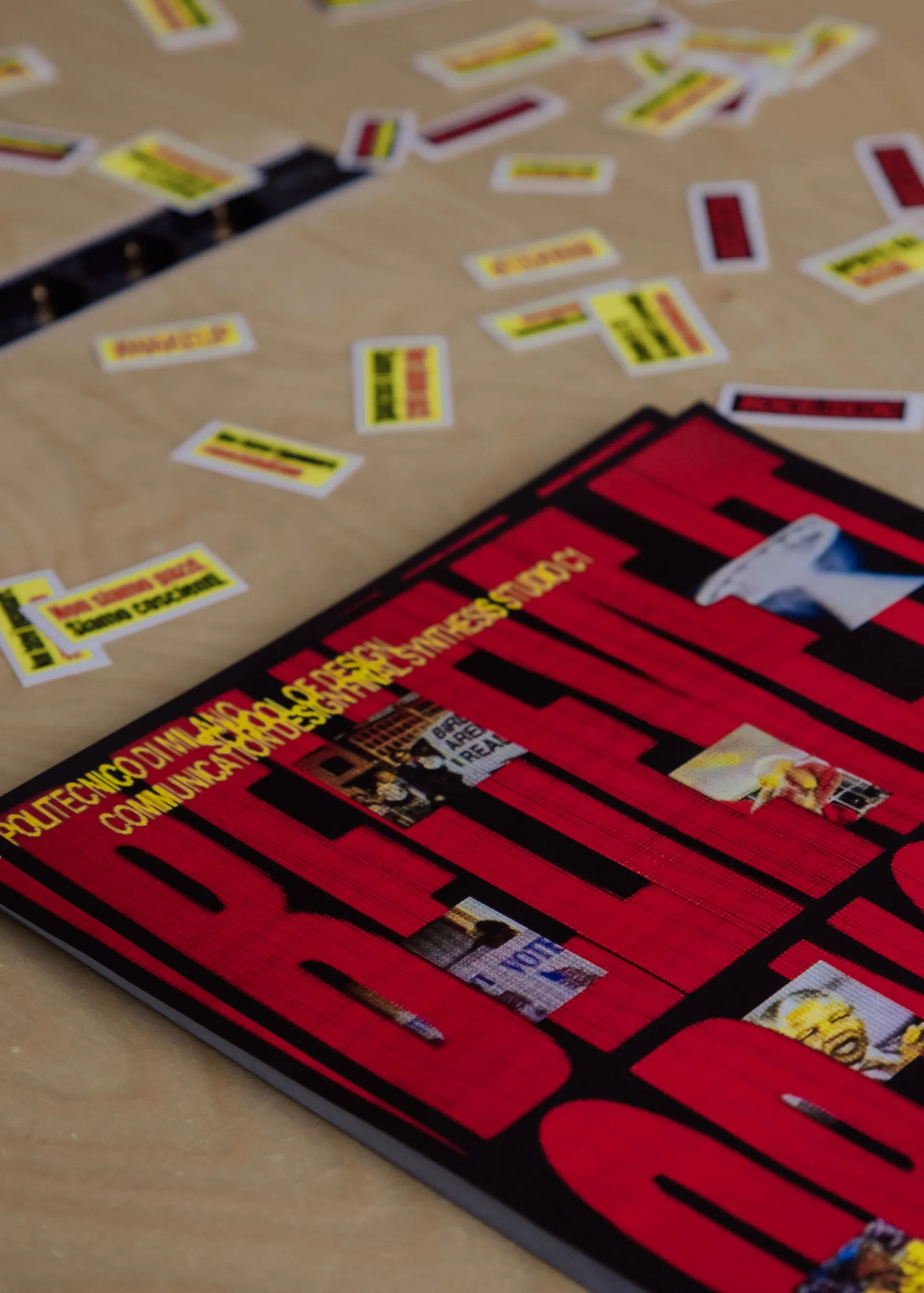 Close-up of the flyer on the table, showing the event details and stickers