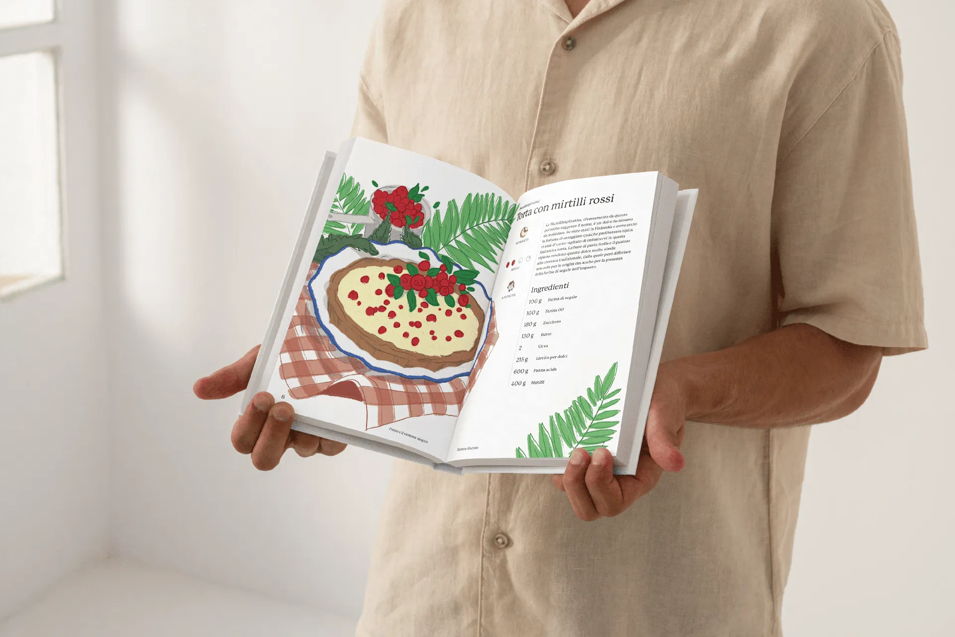 Illustrated recipe book held by a guy